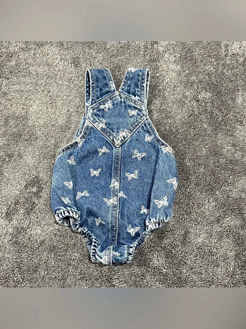 Old Navy jean romper for babies features an all-over white butterfly print 0-3